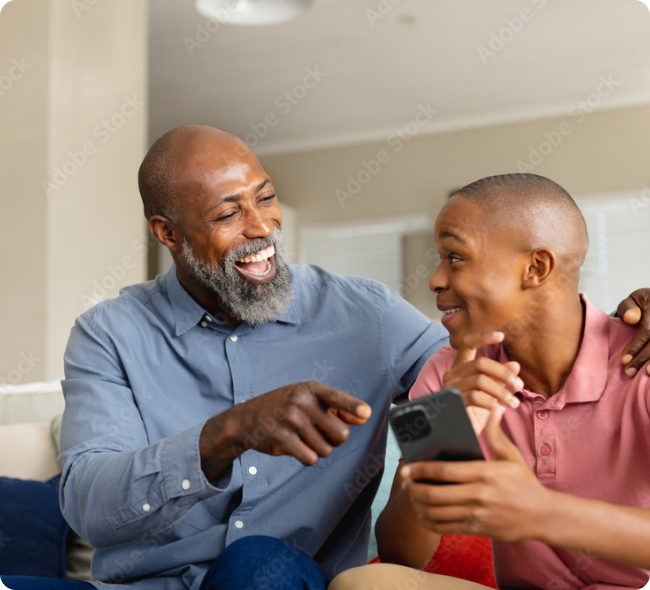 A father and son reviewing information on a phone together